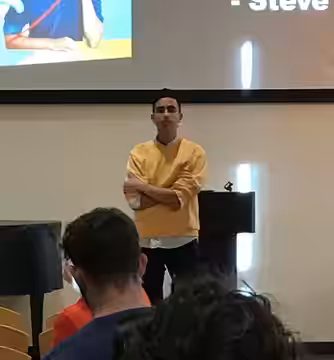 Dylan Marron delivering a presentation on his podcast, Conversations with People who Hate Me (2019)