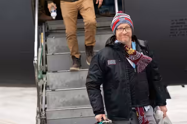 Comedian Matt Walsh exits a C-17 aircraft in Powidz Air Base, Poland; as part of the Chairman's USO New Year's Tour 2020, on Jan. 8, 2020. of the Joint Chiefs o