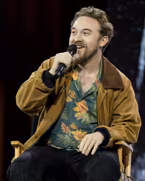 Alex Hirsch addressing the audience during his fireside chat with TheOdd1sOut at Open Sauce 2026 in the San Mateo County Event Center.