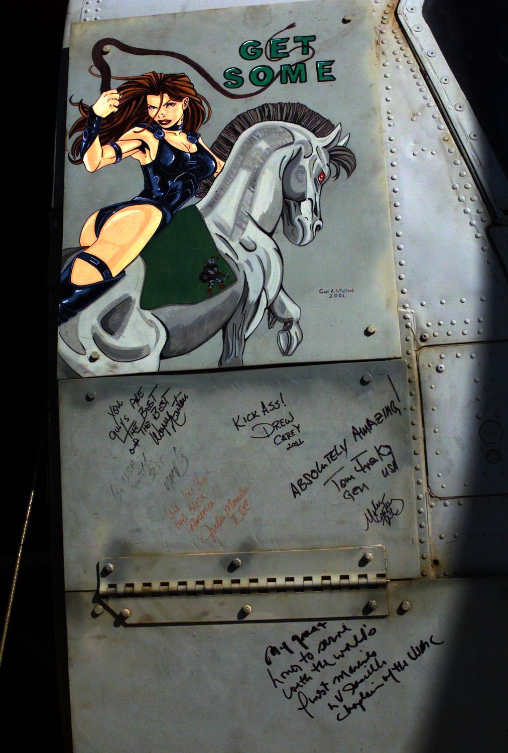 Nose art "Get Some" painted by Captain A. R. Fulford on the front of a Marine CH-46 helicopter from HMM-365 (reinforced). Note the comments penned by Drew Carey (2002)