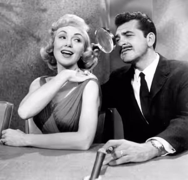 Promotional photo of Ernie Kovacs and Edie Adams from his television show, Take a Good Look. This photo was produced prior to 1978 and has no copyright markings (1960)