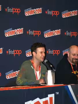 Left to right: actor/comedian Taran Killam and writer Marc Andreyko, speaking on a panel regarding The Illegitimates, the comic book miniseries they created and (2013)