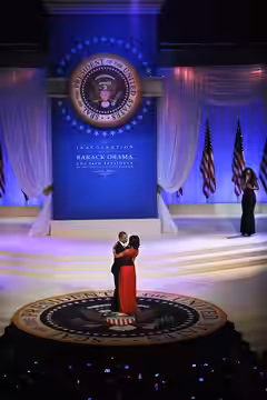 President Barack Obama dances with his wife and first lady of the United States, Michelle Obama, while Jennifer Hudson serenades them during the 2013 Commander 
