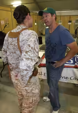Capt. Angella Lawrence, distribution officer for Marine Corps Logistics Command Forward, Marine Forces Central Command, talks to actor D.B. Sweeney at the Unite