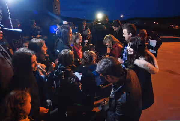 Cast members of the Nickelodeon TV program "iCarly" sign autographs for fans before touring the attack submarine USS Hartford (SSN 768) Jan. 11, 2012, at Naval 