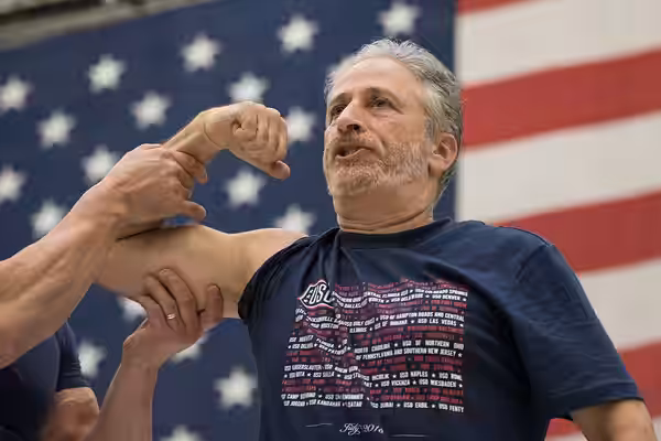 Comedian Jon Stewart flexes for Celebrity Chef Robert Irvine during a show for troops at Bagram Air Field, Afghanistan; the fifth stop on the annual Vice Chairm (2018)