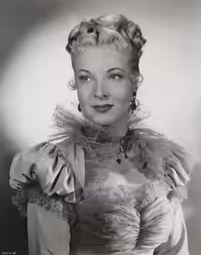 This is a publicity photo, circulated for publicity, of Hillary Brooke, published in the 1951 without copyright notice, qualifying it under public domain.