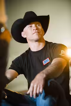 UFC fighter Donald "Cowboy" Cerrone sits on stage during a USO show at Joint Base Elmendorf-Richardson, Alaska, March 12, 2016. Gen. Selva and country music sta