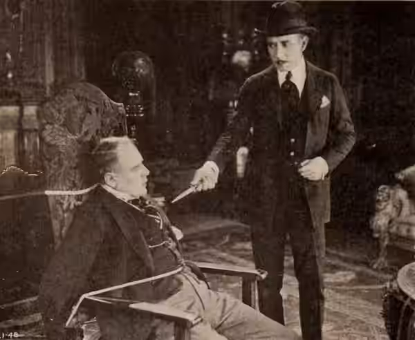 Still from the American mystery film 813 (1920) with an unidentified actor and Wedgwood Nowell, on page 90 of the November 20, 1920 Exhibitors Herald.