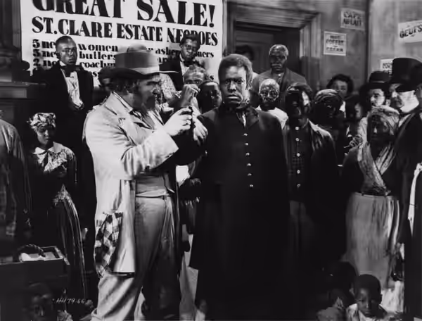 (From left, foreground) George Siegmann and James B. Lowe in the American drama film Uncle Tom's Cabin (1927). The background actors are unidentified.