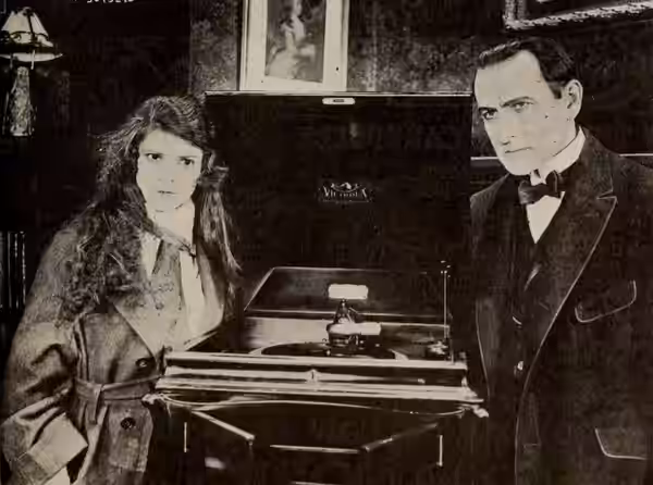Still from the American mystery film The Silk-Lined Burglar (1919) with Sam de Grasse and Priscilla Dean, on page 39 of the April 26, 1919 Exhibitors Herald.