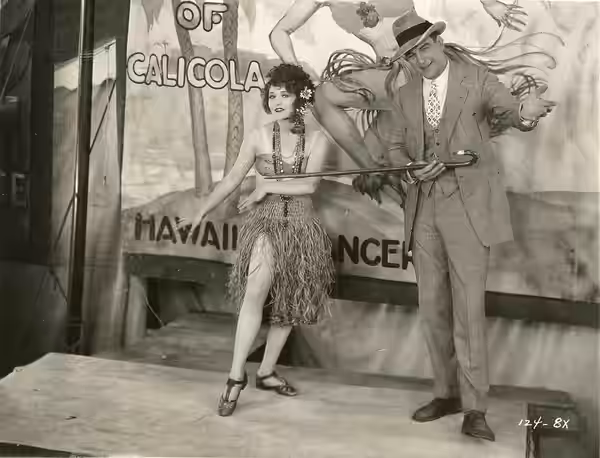 Still from the American drama film The Barker (1928). From the back: "Step Up Ladies and Gentlemen - Milton Sills and the winsome Betty Compson in an interestin