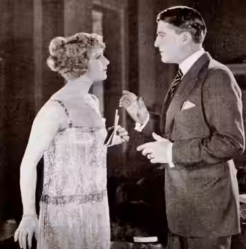 Still from the American comedy film Handle with Care (1922) with Grace Darmond and Landers Stevens, on page 66 of the August 27, 1921 Exhibitors Herald.