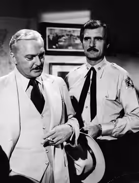 Photo of guest star Jack Cassidy and Dennis Weaver as Sam McCloud from the television series McCloud. (1977)
