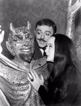 Photo from the television program The Addams Family. In this episode, Uncle Fester's romance sours; Gomez (John Astin) and Morticia (Carolyn Jones) consult the  (1965)