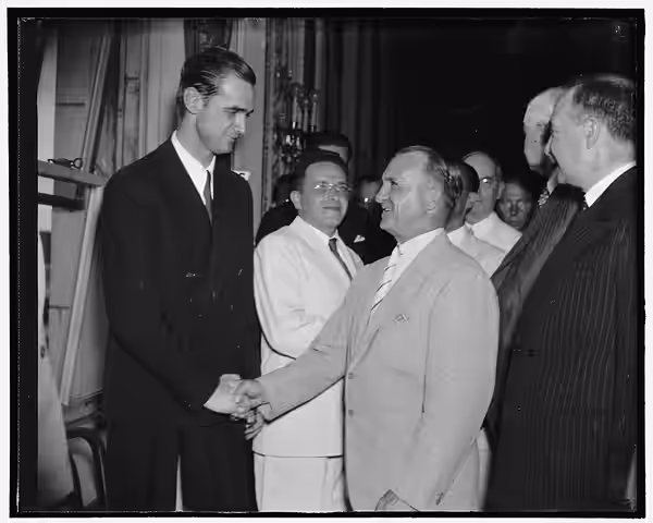 Title: Chief of Army Air Corps congratulates Howard Hughes. Washington, D.C., July 21. Gen. Oscar Westover, Chief of the Army Air Corps, right; Congratulates Ho (1938)