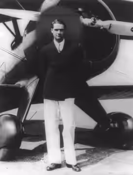Howard Hughes "standing in front of his new Boeing Army Pursuit Plane" (Boeing 100A) in Inglewood, California in the 1940s. The black "halo" is presumably inten