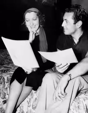 Actress Jeanette MacDonald backstage with actor Allan Jones on the set of The Firefly (1937)