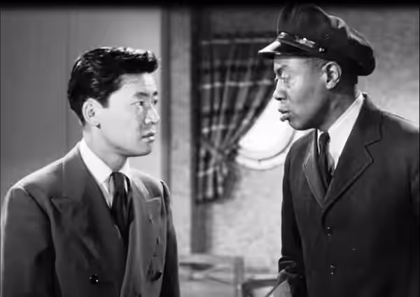 Low resolution screenshot of Victor Sen Yung as Jimmy Chan and Willie Best as Chattanooga Brown from the American film Dangerous Money (1946). The film is in th