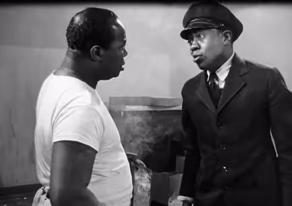 Low resolution screenshot of Dudley Dickerson as Big Ben and Willie Best as Chattanooga Brown from the American film Dangerous Money (1946). The film is in the 