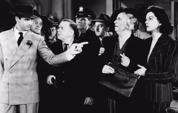 L. to R. : Cary Grant, Frank Jenks, Roscoe Karns, Gene Lockhart, Pat Flaherty, Porter Hall, Alma Kruger, and Rosalind Russell in His Girl Friday (1940). Rosalin