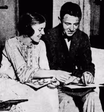 Edna Best, then Mrs. Samuel Beard, and A. E. Matthews, who has just joined her in the cast of 'Quarantine', look at photos of each other's twin sons. (1922)