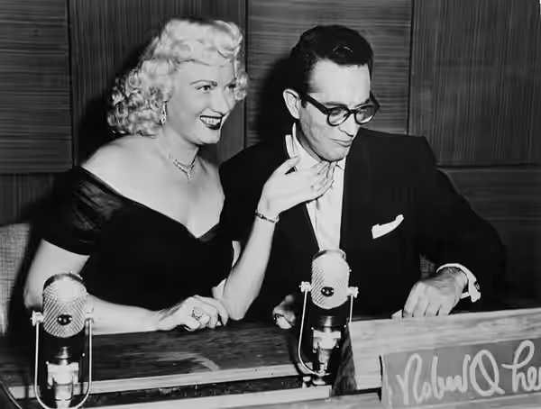Photo from the television game show The Name's the Same. Pictured are host Robert Q. Lewis and celebrity guest Dagmar. (1952)