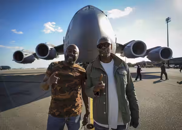 Dave Chappelle (right) and Donnell Rawlings, actors and comedians, stand in front of a C-17 Globemaster III Feb. 2, 2017, at Joint Base Charleston, S.C. Chappel