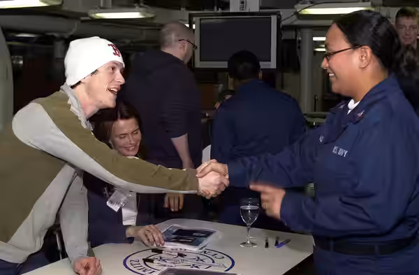 Pacific Ocean (Mar. 21, 2005) - Jonathan Tucker, left, and Serena Scott Thomas, whom star in the new film, "Hostage", sign autographs and greet sailors on the a