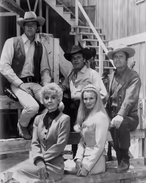 Cast photo from the television Western The Big Valley. Back, from left-Lee Majors, Peter Breck, Richard Long. Front-Barbara Stanwyck, Linda Evans.