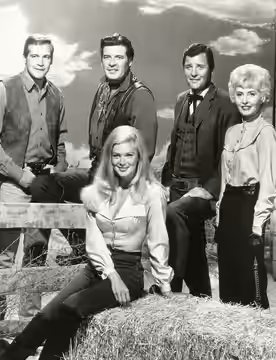 Photo of The Big Valley cast for 1967. Clockwise, from back: Lee Majors, Peter Breck,Richard Long, Barbara Stanwyck and Linda Evans.