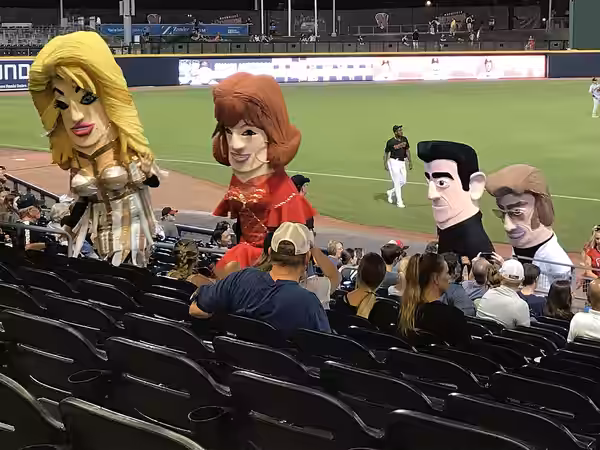 Caricature mascots of country musicians Dolly Parton, Reba McEntire, Johnny Cash, and George Jones after racing around First Tennessee Park during the fifth inn (2018)