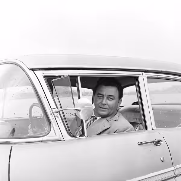Photograph of the Finnish vocalist Olavi Virta sitting in his Chevrolet Bel Air. (1958)