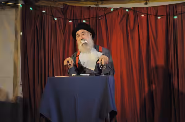 Avner the Eccentric (Avner Eisenberg) performing at Chumleighland, Camano Island, Washington, USA. Part of a routine in which Avner sits down at a dinner settin (2009)