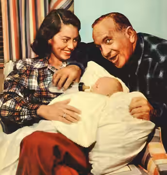 Photo of Al and Erle Jolson with their adopted son, Asa. (1948)