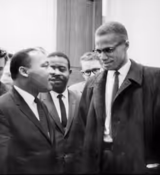 Martin Luther King, Jr. and Malcolm X meet before a press conference. Both men had come to hear the Senate debate on the Civil Rights Act of 1964. This was the 