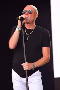 Glenn Gregory of Heaven 17 performing at Let's Rock Liverpool, 31 July 2021. Let's Rock is a one day retro music festival concentrating on 80s music, particular