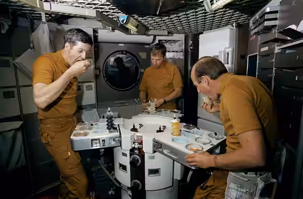 Skylab 2 astronauts eat space food in wardroom of Skylab trainer The three members of the prime crew of the first manned Skylab mission dine on specially prepar