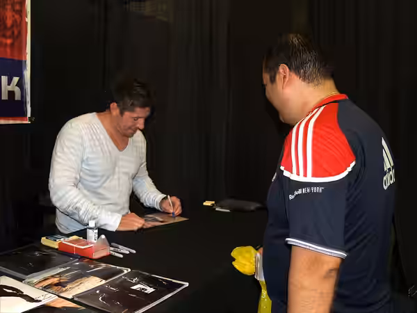 British &amp; Scottish Actor, Martial Artist and Author Ray Park signing autographs for a fan at the 2013 Wizard World New York Experience Comic Con, at Pier 36