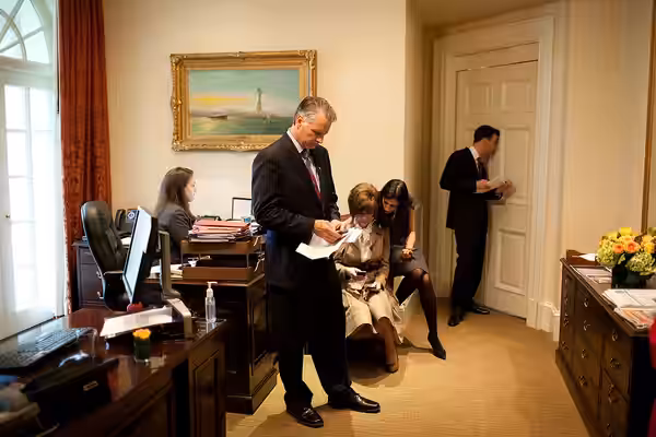 Brian Mosteller, deputy director of Oval Office operations, looks through a peephole in the Oval Office door to monitor the progress of the bilateral meeting be (2009)