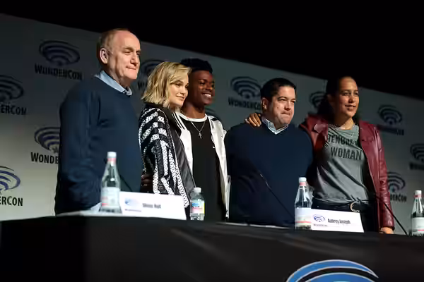Jeph Loeb, Olivia Holt, Aubrey Joseph, Joe Pokaski and Gina Prince-Bythewood speaking at the 2018 WonderCon, for "Cloak &amp; Dagger", at the Anaheim Convention