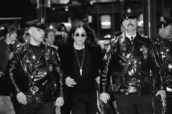 Ozzy Osbourne, flanked by Philadelphia police officers, leaves Borders in Center City after signing copies of his new autobiography, "I Am Ozzy," on Jan. 27, 20 (2010)