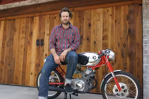 Jason Lee sitting on his Lossa built Honda CB160 Cafe Bike