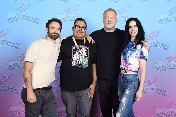 Actors, Charlie Cox and Vincent D'Onofrio and actress Krysten Ritter taking a photo with a fan at GalaxyCon Austin in 2023.