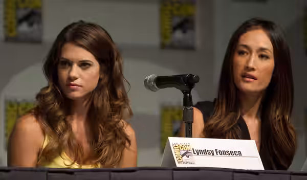 Lyndsy Fonseca and Maggie Q at a panel for the television series Nikita at San Diego Comic-Con in July 2010.