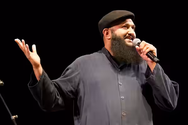 Photo: Azhar Usman, Chicago-based standup comedian on stage at the 2017 Festival of Faiths A nationally acclaimed multifaith festival of music, poetry, art, fil