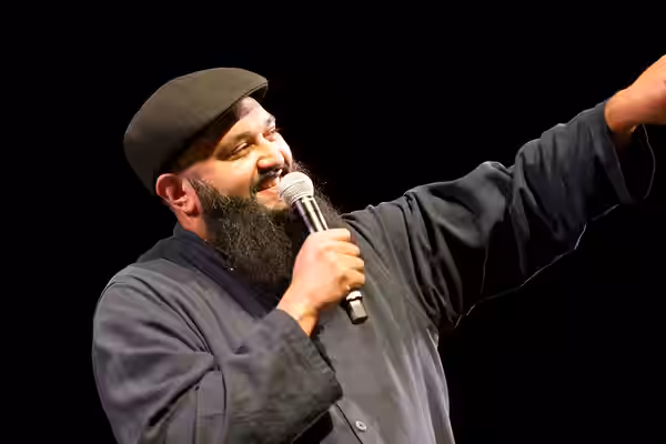 Photo: Azhar Usman, Chicago-based standup comedian on stage at the 2017 Festival of Faiths A nationally acclaimed multifaith festival of music, poetry, art, fil