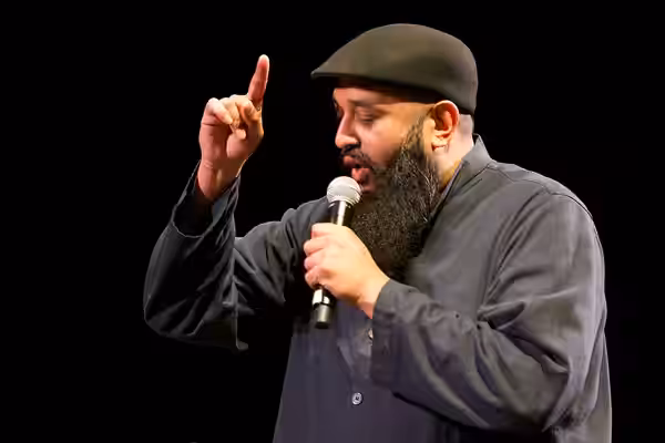 Photo: Azhar Usman, Chicago-based standup comedian on stage at the 2017 Festival of Faiths A nationally acclaimed multifaith festival of music, poetry, art, fil