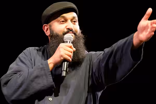Photo: Azhar Usman, Chicago-based standup comedian on stage at the 2017 Festival of Faiths A nationally acclaimed multifaith festival of music, poetry, art, fil