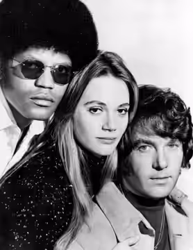 Publicity photo from the television program The Mod Squad. The main cast is pictured, from left: Clarence Williams III, Peggy Lipton, Michael Cole.